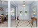 Inviting foyer with tile flooring, decorative columns, and a view into the dining room at 19808 Seaview St, Orlando, FL 32833