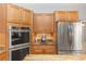 Stainless steel appliances and wood cabinets in this kitchen at 19808 Seaview St, Orlando, FL 32833