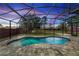 Inviting private swimming pool enclosed by a screened lanai and brick pavers, perfect for outdoor enjoyment at 19808 Seaview St, Orlando, FL 32833