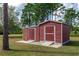 Red storage shed with double doors and concrete base at 19808 Seaview St, Orlando, FL 32833