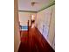 Upstairs hallway with hardwood floors and neutral walls leading to bedrooms at 211 River Bluff Dr, Ormond Beach, FL 32174