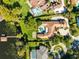 Expansive property showcasing a large home, pool, and private lake access on a sunny day at 4024 W Danby Ct, Winter Springs, FL 32708