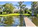 Sprawling backyard featuring a lakefront view, luscious green grass, and a private dock at 4024 W Danby Ct, Winter Springs, FL 32708