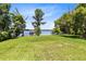 Sprawling backyard featuring a lakefront view, luscious green grass, and a gazebo on the dock at 4024 W Danby Ct, Winter Springs, FL 32708