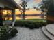 View from patio showcasing lakefront view, lush landscaping, and beautiful sunset at 4024 W Danby Ct, Winter Springs, FL 32708