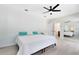 Neutral bedroom featuring light wood flooring, ceiling fan, and an ensuite bathroom with mirror at 4024 W Danby Ct, Winter Springs, FL 32708