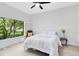 Bedroom features natural light and neutral decor with a large window overlooking the garden at 4024 W Danby Ct, Winter Springs, FL 32708