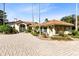 Exterior of home showcasing circular driveway, terracotta roof, and lush landscaping at 4024 W Danby Ct, Winter Springs, FL 32708