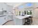 Bright kitchen with marble countertops, an island with seating, and stainless steel appliances at 4024 W Danby Ct, Winter Springs, FL 32708