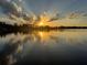 Beautiful sun rays over the lake reflecting on the water, offering a serene, picturesque view at 4024 W Danby Ct, Winter Springs, FL 32708