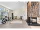 Stylish living room featuring wood-look floors, accent wall fireplace, and natural light at 4024 W Danby Ct, Winter Springs, FL 32708
