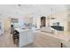 Open-concept living room with modern kitchen, fireplace, and comfortable seating at 4024 W Danby Ct, Winter Springs, FL 32708