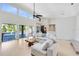 Open living room with a view of the pool and lake, featuring high ceilings and tile floors at 4024 W Danby Ct, Winter Springs, FL 32708