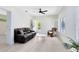 Bright living room with comfortable seating, white tile floors, and seamless indoor-outdoor living at 4024 W Danby Ct, Winter Springs, FL 32708