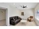 Inviting living room with a plush leather sofa, cozy wicker chair, and bright windows for a relaxing atmosphere at 4024 W Danby Ct, Winter Springs, FL 32708