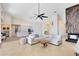 Open-concept living room with modern fireplace, ceiling fan, and view of the kitchen at 4024 W Danby Ct, Winter Springs, FL 32708