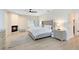 Bright main bedroom features a fireplace, ceiling fan, wood-look floors and stylish furnishings at 4024 W Danby Ct, Winter Springs, FL 32708