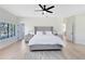 Bright main bedroom features a ceiling fan, wood-look floors, and two closets at 4024 W Danby Ct, Winter Springs, FL 32708