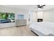 Spacious main bedroom with wood-look floors and large window overlooking waterfront at 4024 W Danby Ct, Winter Springs, FL 32708