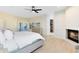 Bright main bedroom featuring a fireplace, ceiling fan, private doors to the patio and a walk-in closet at 4024 W Danby Ct, Winter Springs, FL 32708