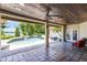 Covered patio featuring brick tiling, ceiling fans, and a view of the private pool and lake at 4024 W Danby Ct, Winter Springs, FL 32708