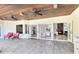 Spacious outdoor patio with a tile floor, ceiling fans, and an open view to the living and kitchen areas at 4024 W Danby Ct, Winter Springs, FL 32708