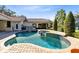 Outdoor pool and spa with a paver deck and beautiful landscaping, perfect for relaxation and entertainment at 4024 W Danby Ct, Winter Springs, FL 32708