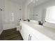 Bathroom featuring double sinks and a tub with tiled walls at 5280 Teirgarten St, Saint Cloud, FL 34771