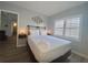 Bright bedroom featuring plantation shutters, queen bed, and modern decor at 6165 Carrier Dr # 2602, Orlando, FL 32819