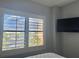 Bedroom window with plantation shutters and a view of the lake at 6165 Carrier Dr # 2602, Orlando, FL 32819