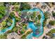 Aerial view of resort pool area with lazy river, slides, and lounge chairs at 7740 Sandy Ridge Dr # 121, Reunion, FL 34747