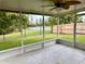 Screened porch overlooking a pond and grassy backyard at 12845 Parkbury Dr, Orlando, FL 32828