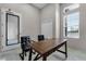 A home office featuring light walls, window, closet, desk, and two black, upholstered chairs at 308 Barebow Ln, Ormond Beach, FL 32174