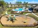 Aerial view of the community playground with slides and swing sets, next to the community pool at 308 Barebow Ln, Ormond Beach, FL 32174