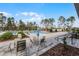 Chairs and tables on the pool deck offer a relaxing space for residents at 308 Barebow Ln, Ormond Beach, FL 32174