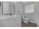 Bathroom with white vanity, toilet, and bathtub at 5023 Golf Club Pkwy, Orlando, FL 32808