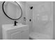 Updated bathroom with a walk-in shower and sleek black and white finishes at 5023 Golf Club Pkwy, Orlando, FL 32808