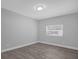 Simple bedroom with gray walls and a window at 5023 Golf Club Pkwy, Orlando, FL 32808