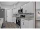 Bright kitchen with stainless steel appliances, white cabinets, and stylish backsplash at 5023 Golf Club Pkwy, Orlando, FL 32808