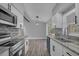 Kitchen view featuring white cabinets, granite counters, and stainless appliances at 5023 Golf Club Pkwy, Orlando, FL 32808