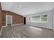 Spacious living room featuring a brick wall accent and light gray walls at 5023 Golf Club Pkwy, Orlando, FL 32808