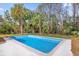 Refreshing blue pool surrounded by lush landscaping at 5023 Golf Club Pkwy, Orlando, FL 32808