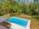 Aerial view of the backyard pool surrounded by tropical landscaping at 5023 Golf Club Pkwy, Orlando, FL 32808