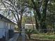 Landscaped backyard with mature trees and a walkway at 5528 Flamingo Ave, Lakeland, FL 33809