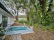 Backyard patio with tropical print rug and lush landscaping at 5528 Flamingo Ave, Lakeland, FL 33809