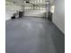 Spacious garage with overhead door and painted floor at 5528 Flamingo Ave, Lakeland, FL 33809