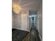 Long hallway with dark hardwood floors and a chandelier at 5528 Flamingo Ave, Lakeland, FL 33809