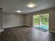 Spacious living room with wood-look flooring and sliding glass doors at 5528 Flamingo Ave, Lakeland, FL 33809