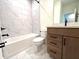 Bathroom featuring tiled bathtub and wooden vanity with dark fixtures at 15106 Grove Lake Dr, Winter Garden, FL 34787
