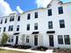 Modern townhouse with white siding, black trim, and well-maintained landscaping at 15106 Grove Lake Dr, Winter Garden, FL 34787